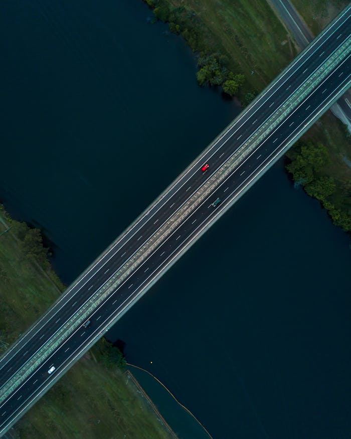 Drone shot capturing a bridge over a river in Leonay, NSW, showcasing transportation and nature.
